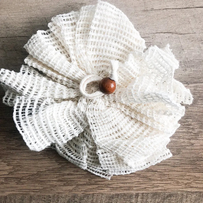 White textured flower with a brown center on a wooden surface