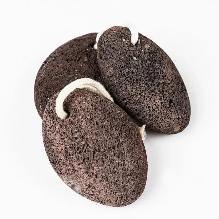 Three brown pumice stones on a white background