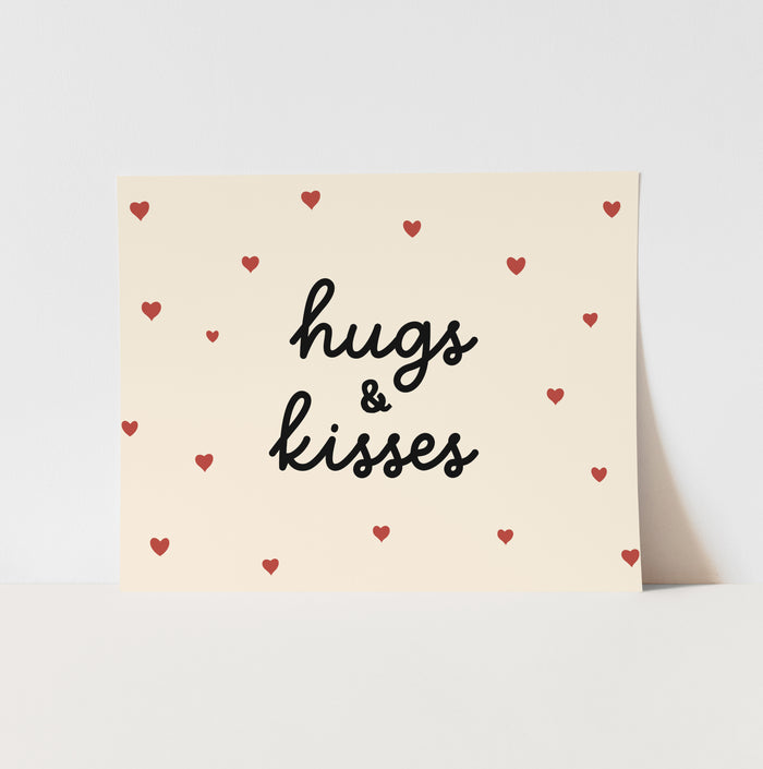 Card with 'hugs & kisses' text and red hearts on a beige background