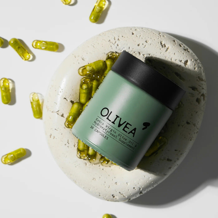 Four yellow capsules on a white surface, with the text “More potent than an olive oil shot” above them—each OLIVEA EVOO & HYDROXYTYROSOL SUPPLEMENT delivers a concentrated 20 mg dose of olive polyphenols and hydroxytyrosol, powerful compounds from high-phenolic olive oil by OLIVEA.
