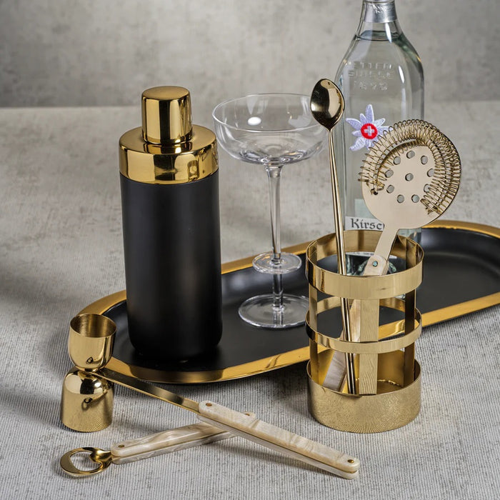 The ZODAX OVAL TRAY - BLACK WITH GOLD BORDER is a modern serving tray with a matte black oval base and a bold gold rim, shown elegantly on a white background.