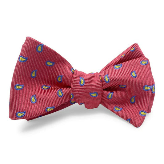 The BIRD DOG BAY PETER-BLAIR Cape Cod silk bow tie in red is handmade with a ribbed texture and features evenly distributed small blue and yellow paisley motifs. Adjustable for a perfect fit.
