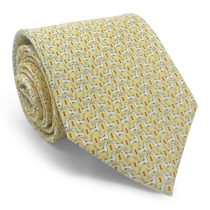 The BIRD DOG BAY PETER-BLAIR Jack Russell printed silk tie in yellow features a repeating dog motif and is handmade in New York.