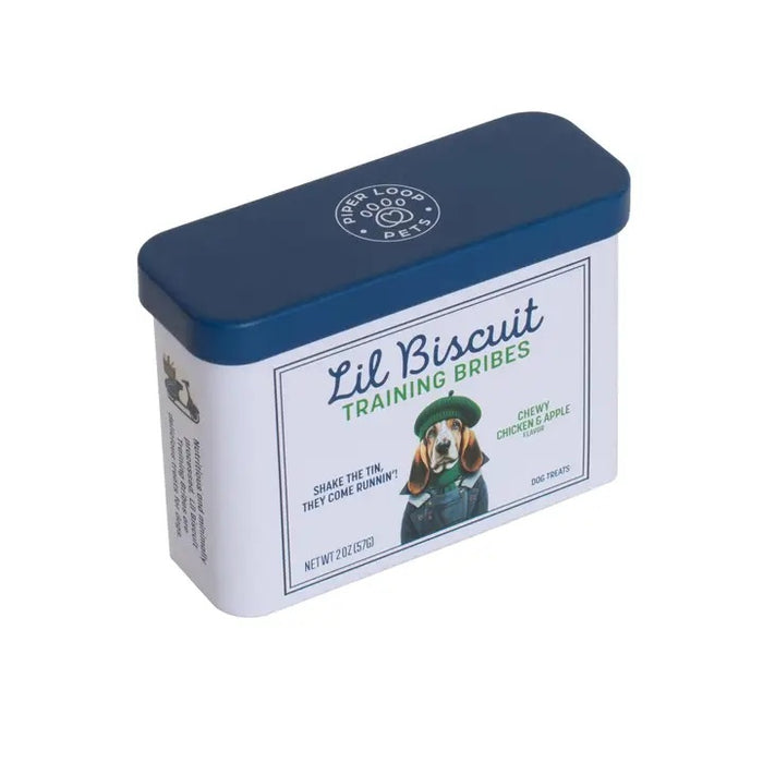 A rectangular, refillable tin labeled "PIPER LOOP PETS - LIL BISCUIT TRAINING BRIBES, CHEWY CHICKEN & APPLE," with a dog in a green sweater—chewy USA-sourced dog treats. Shake the tin, they come running!.