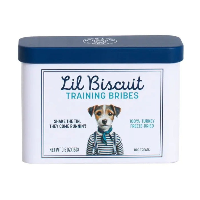 A rectangular tin with a blue lid labeled “PIPER LOOP PETS - LIL BISCUIT TRAINING BRIBES, FREEZE-DRIED TURKEY” features a puppy photo and contains 100% turkey, protein-rich treats for training and emergency recall.