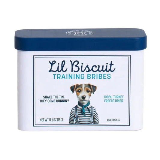 A rectangular tin with a blue lid labeled “PIPER LOOP PETS - LIL BISCUIT TRAINING BRIBES, FREEZE-DRIED TURKEY” features a puppy photo and contains 100% turkey, protein-rich treats for training and emergency recall.