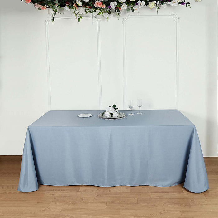 Elegant blue tablecloth draped over a table with decorative items.