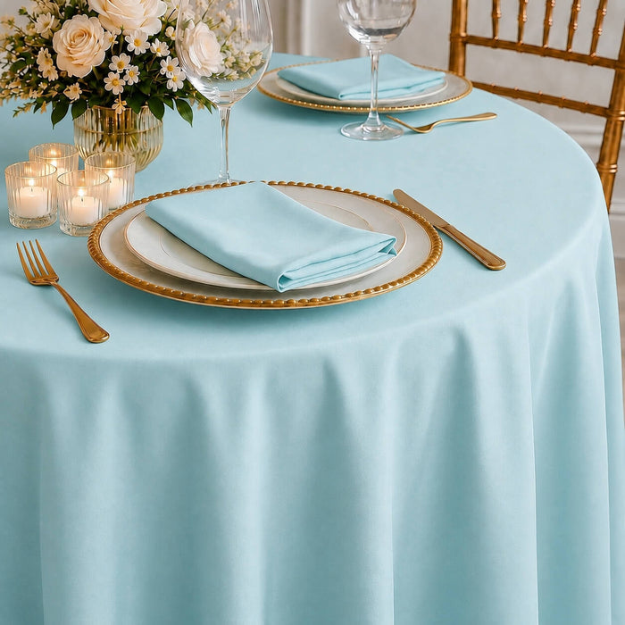 Light blue polyester round tablecloth on a beautifully set table.