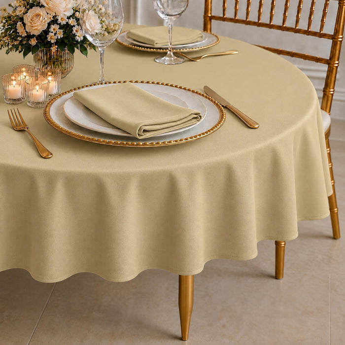 Champagne round tablecloth with linen texture on a dining table setting.