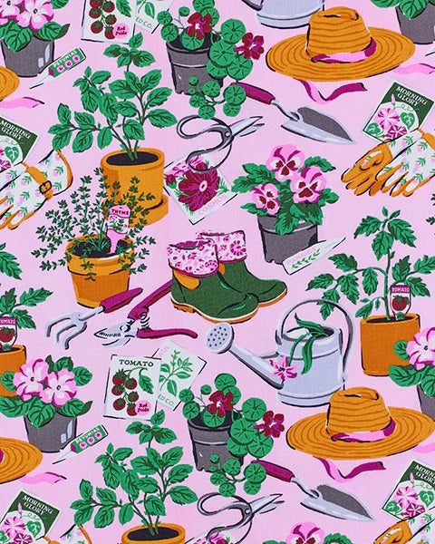 A person in a white shirt holds the PRINTFRESH - GREEN THUMB THREE POUCH SET by PRINTFRESH, featuring three quilted travel pouches with floral and striped patterns, stacked from largest to smallest, against a plain background.