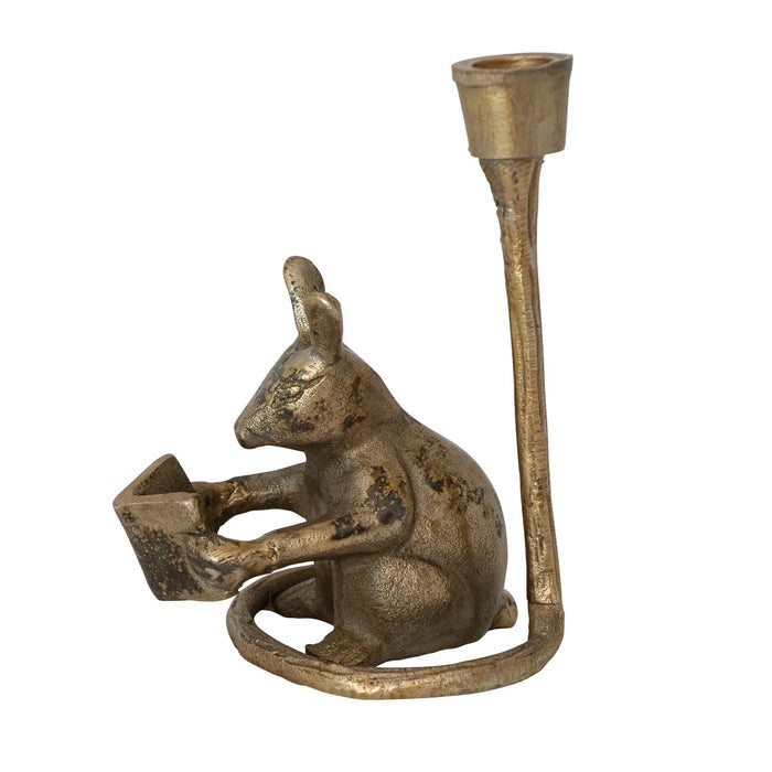 The READING MOUSE CAST ALUMINUM TAPER HOLDER by CREATIVE COOP features a charming mouse reading upright in an antique gold finish, with a candle holder above its head—a playful accent for your space.