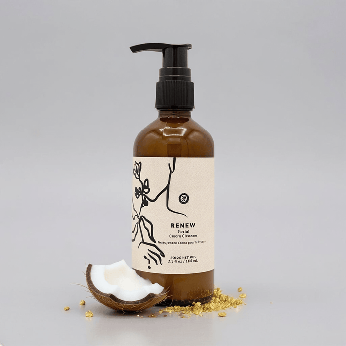 Brown bottle with pump and 'RENEW' label on a gray background with coconut pieces.
