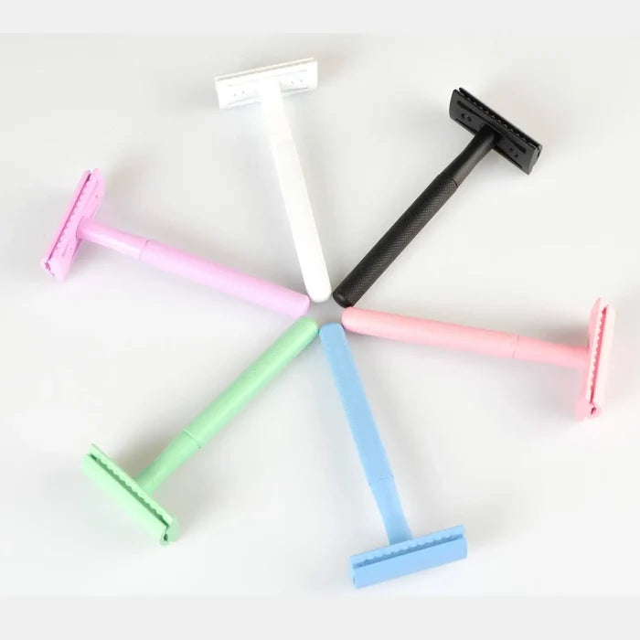 Set of colorful safety razors on a white background