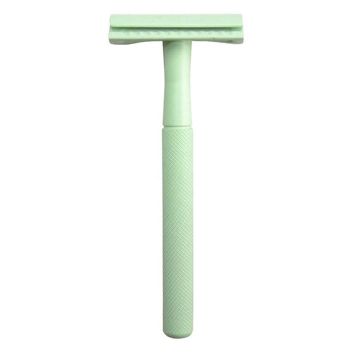 Green safety razor on a white background