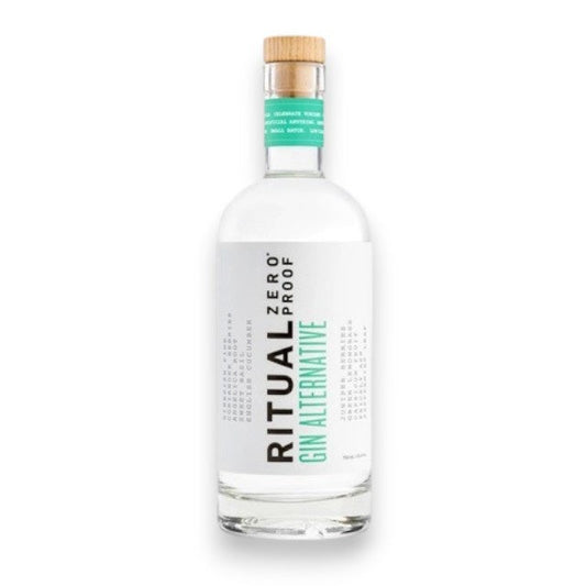 A clear bottle of RITUAL ZERO PROOF-GIN ALTERNATIVE by RITUAL ZERO PROOF, featuring a white label with black and green text and a wooden cap, displayed against a plain white background.