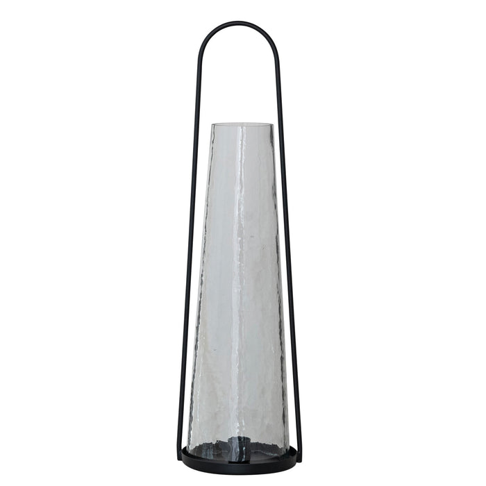 The ROUND METAL LANTERN TAPER HOLDER WITH HAMMERED GLASS HURRICANE by CREATIVE COOP features a tall, black metal frame and a cone-shaped hammered glass hurricane for a modern, minimalist look with sleek lines and transparent materials.