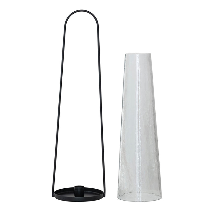 The CREATIVE COOP ROUND METAL LANTERN TAPER HOLDER features a tall, hammered glass hurricane in a minimalist black metal frame with a rounded handle—ideal as a lantern holder for modern spaces.