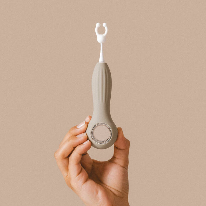 Hand holding the Samphire Precision Vibrator, featuring interchangeable heads for customized pleasure.