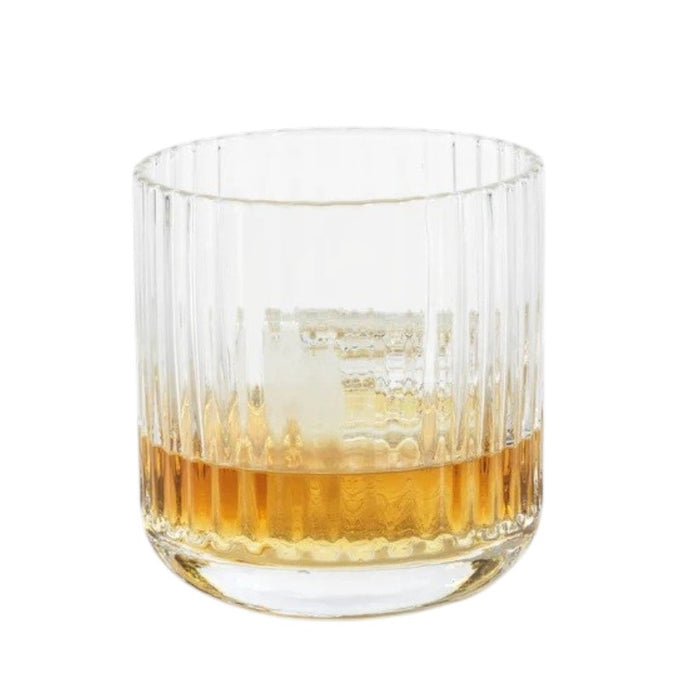 The SAVOY DOUBLE OLD FASHIONED GLASS by ZODAX, featuring clear ribbed glass with vertical ridges, sits on a white background and casts a soft reflection below.