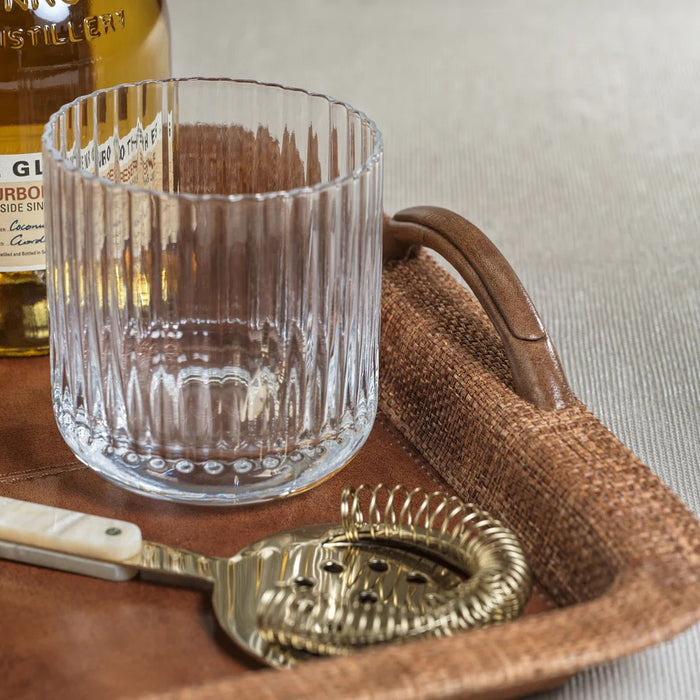 The SAVOY DOUBLE OLD FASHIONED GLASS by ZODAX, featuring clear ribbed glass with vertical ridges, sits on a white background and casts a soft reflection below.
