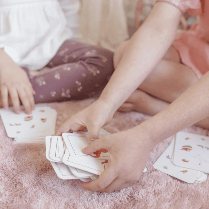 Children playing the Sesame Street 3-in-1 Card Game, focusing on emotional intelligence and joyful play.