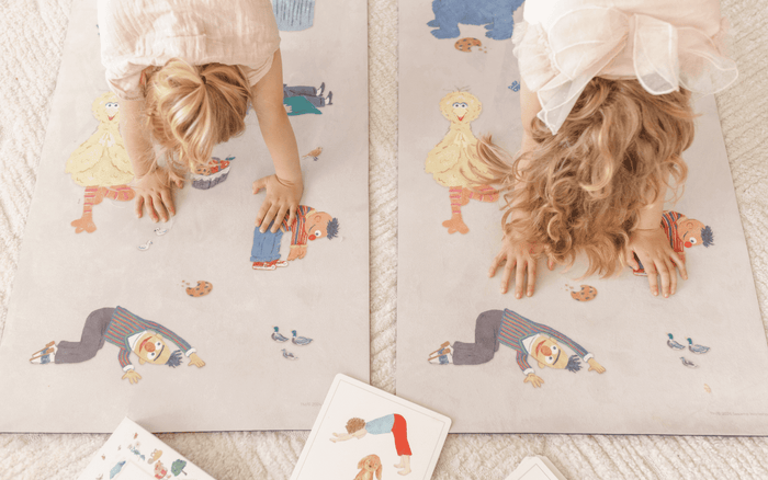 Kids enjoying yoga poses on Sesame Street Print Kids Yoga Mat with colorful character designs and yoga flash cards.