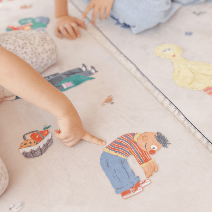 Children playing on a Sesame Street Print Kids Yoga Mat featuring colorful characters and poses.