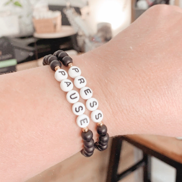 Set of 2 Press Pause Bracelets in Black: "Press Pause"