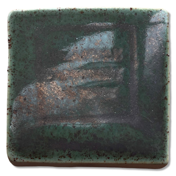 SP52 Shadow Green glaze test tile, speckled green with a metallic bronze sheen across the center
