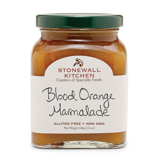 A jar of STONEWALL KITCHEN - BLOOD ORANGE MARMALADE from STONEWALL KITCHEN features a green lid and a white label with handwritten-style text, highlighting details like “Gluten Free” and “Non GMO.” Crafted from ripe blood oranges, this sweet marmalade offers a vibrant, citrusy flavor.