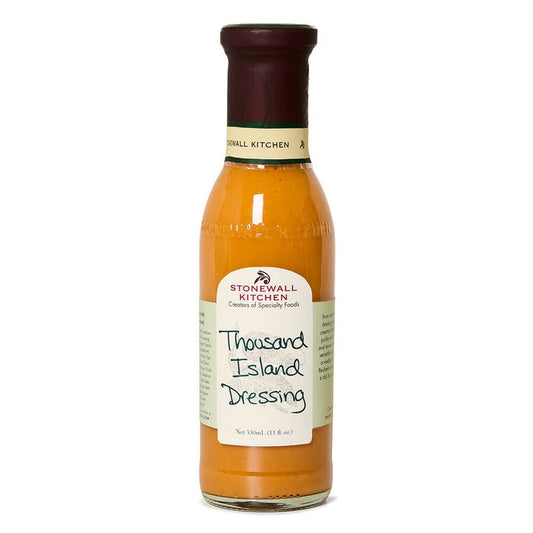 A bottle of STONEWALL KITCHEN - THOUSAND ISLAND DRESSING by STONEWALL KITCHEN, ideal for Reuben sandwiches or as a gourmet salad dressing, featuring an orange label and maroon cap, is displayed upright against a white background.