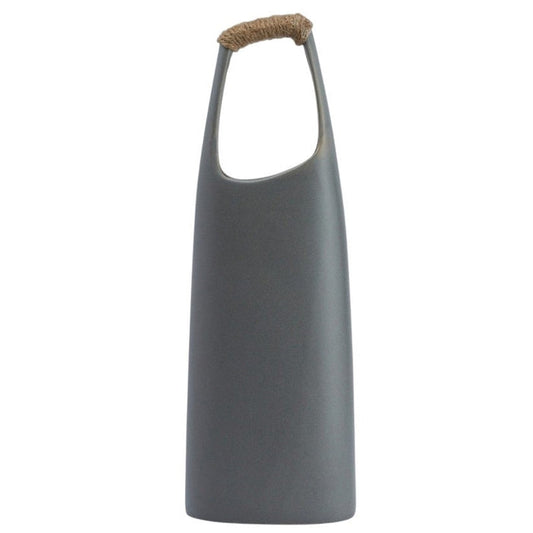The CREATIVE COOP STONEWARE VASE WITH RATTAN WRAPPED HANDLE, GREY, stands tall with a matte finish and elongated oval opening, making a striking decorative centerpiece against a white background.