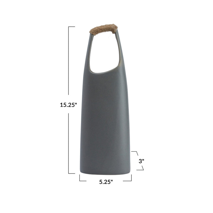 The CREATIVE COOP STONEWARE VASE WITH RATTAN WRAPPED HANDLE, GREY, stands tall with a matte finish and elongated oval opening, making a striking decorative centerpiece against a white background.