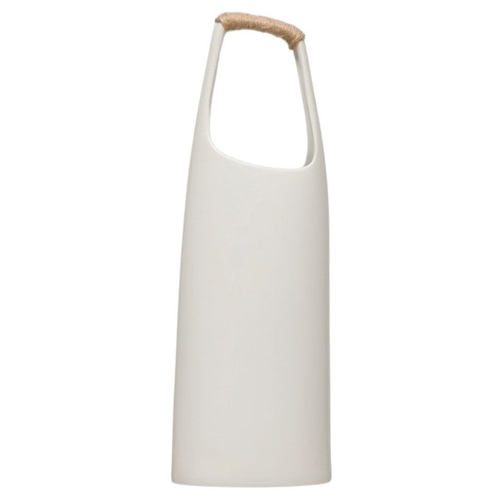 The CREATIVE COOP STONEWARE VASE WITH RATTAN WRAPPED HANDLE in white features a tall, minimalist design with a narrow neck and a rattan-wrapped handle, making it a striking decorative accent for any space.