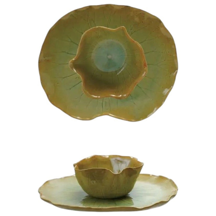 The CREATIVE COOP STONEWARE WATER LILY PLATE WITH BOWL features a green lotus leaf shape and reactive crackle glaze, displayed together against a plain gray background.
