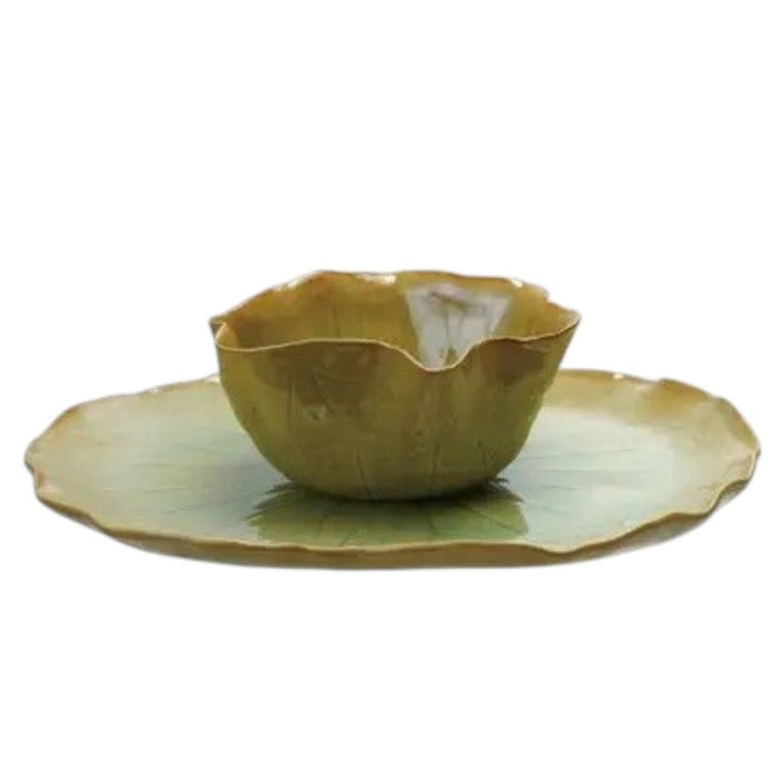 The CREATIVE COOP STONEWARE WATER LILY PLATE WITH BOWL IN REACTIVE CRACKLE GLAZE features veined, green leaf shapes and wavy edges, resembling natural leaves from the side view.