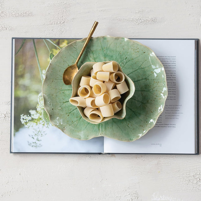 The CREATIVE COOP STONEWARE WATER LILY PLATE WITH BOWL features a green lotus leaf shape and reactive crackle glaze, displayed together against a plain gray background.