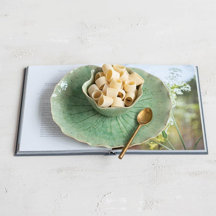 The CREATIVE COOP STONEWARE WATER LILY PLATE WITH BOWL IN REACTIVE CRACKLE GLAZE features veined, green leaf shapes and wavy edges, resembling natural leaves from the side view.