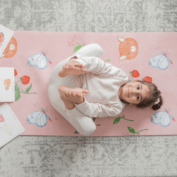 Sweet Print Kids Yoga Mat featuring a child practicing yoga on a colorful mat with animal and butterfly designs.