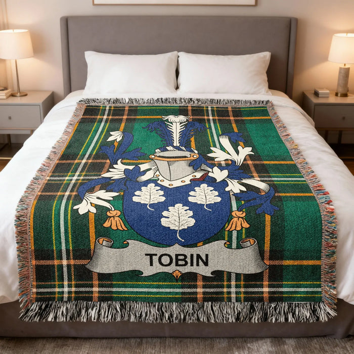 Tobin Irish family crest woven blanket displayed on a bed.