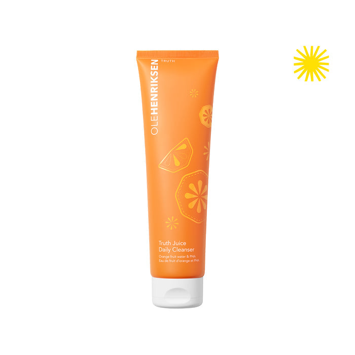 Closed bottle of Truth Juice Daily Cleanser on a white background. Upper right corner has an icon of a yellow sun.