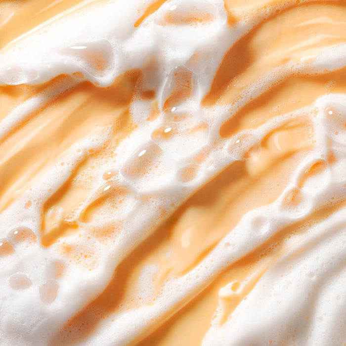 Texturized and foamy orange image of Truth Juice Daily Cleanser.