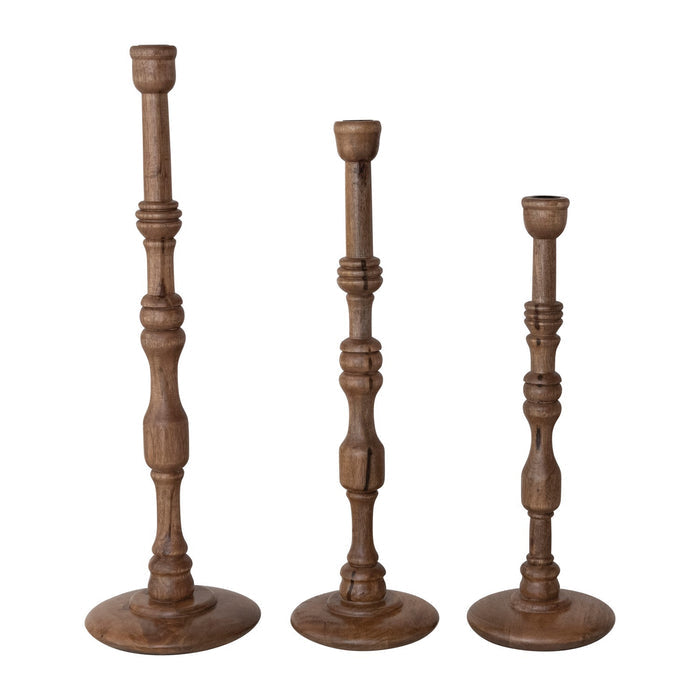 The CREATIVE COOP TURNED MANGO WOOD TAPER HOLDER, LARGE, is a wooden candlestick holder featuring traditional turned woodwork, carved details, and a round base, shown upright on a white background.