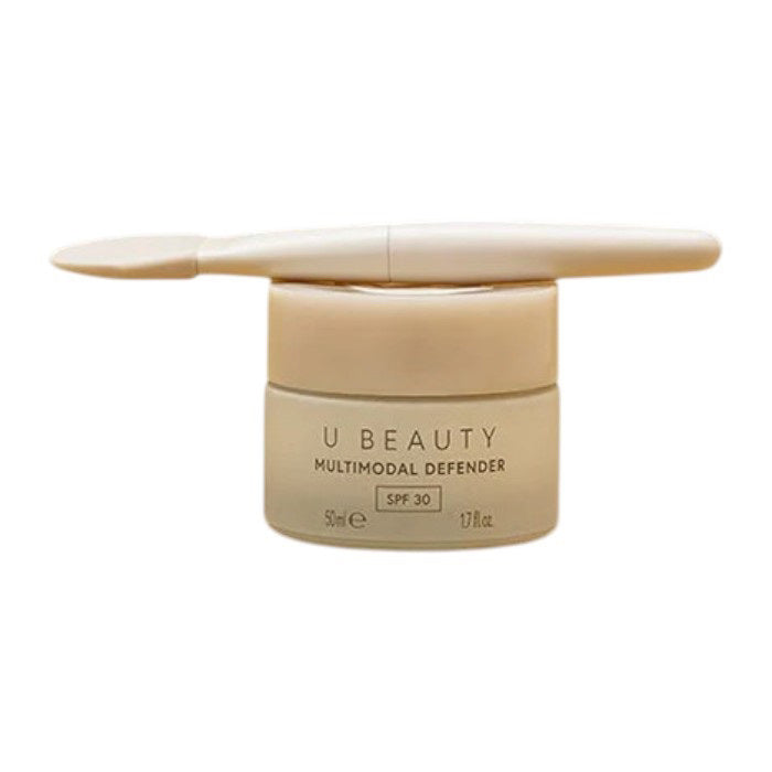 THE BRUSH by U BEAUTY is a white silicone skincare applicator featuring a flat, rounded tip and "U BEAUTY" on the handle—crafted for precision application against a clean, white background.