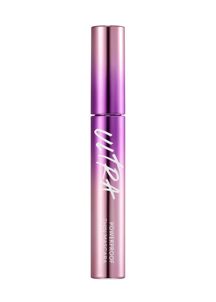 A tube of MISSHA Ultra Powerproof Thin Mascara with a brush, displayed on a reflective surface with a colorful, holographic background.