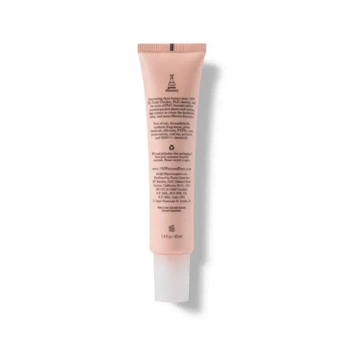 Pink skincare tube with text on a white background