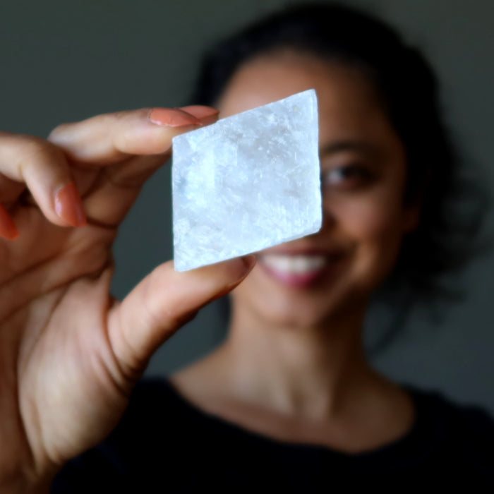 woman holding optical calcite crystal